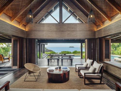 a living room with a table and a couch at Six Senses Fiji in Malolo