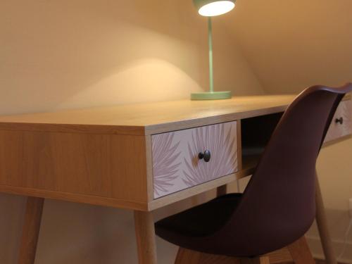 a desk with a chair and a lamp on it at Gîte haut de gamme près de l'Abbaye de Noirlac - Séjour tout confort avec jardin et terrasses - FR-1-586-13 in Bruère-Allichamps