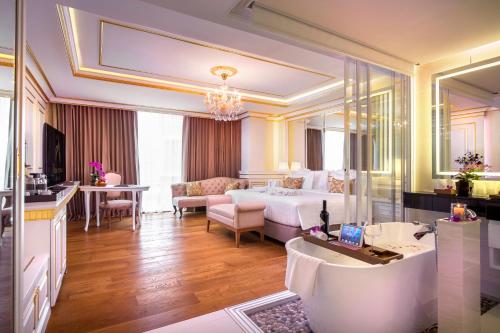 a hotel room with a bed and a bathroom at Amaranta Hotel - SHA Plus in Bangkok