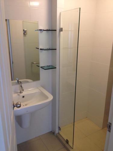 a bathroom with a sink and a glass shower at The Trust Hua Hin Green and Blue Room Service in Hua Hin