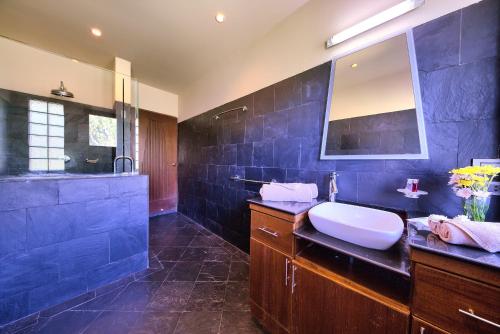 a blue bathroom with a sink and a mirror at Villa Seven Swifts - Bangrak Ocean View in Bophut 