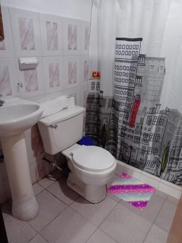 a bathroom with a toilet and a sink at Apto CUEVA DEL OSO PARAMILLO 2 Hab 4 Pax in San Cristóbal