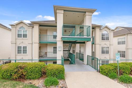 a apartment building with a staircase in front of it at Little House on the 12th Hole - Luxury Golf Condo in Branson