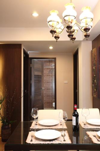 a dining room with a table with two wine glasses at Amaranta Hotel in Bangkok