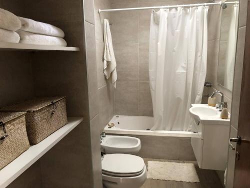 a bathroom with a toilet and a sink and a shower at Casa bohé Casilda in Casilda