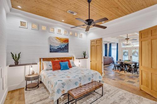 a bedroom with a bed and a ceiling fan at Bare Feet Beach House Close to beach dog friendly in Gulfport