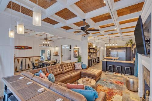 a large living room with a couch and a kitchen at Bare Feet Beach House Close to beach dog friendly in Gulfport