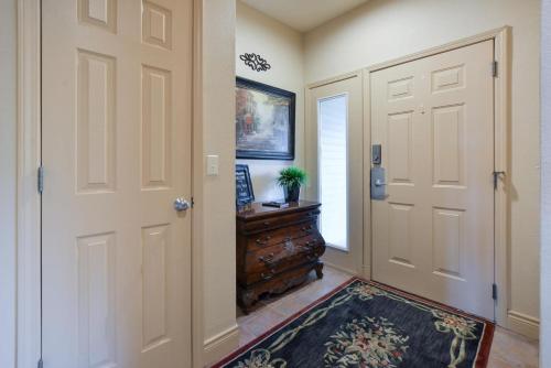 a hallway with a door and a dresser with a rug at Tuscany Villas - In the heart of Branson in Branson