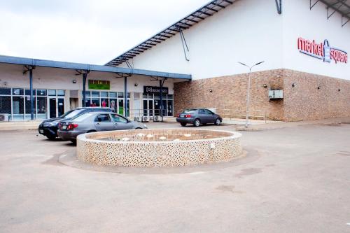 a building with cars parked in a parking lot at UNIA Homes in Benin City