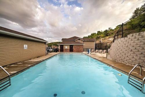 a large blue swimming pool next to a building at Glam R Us - Pool - Fabulous Location Must Stay in Branson