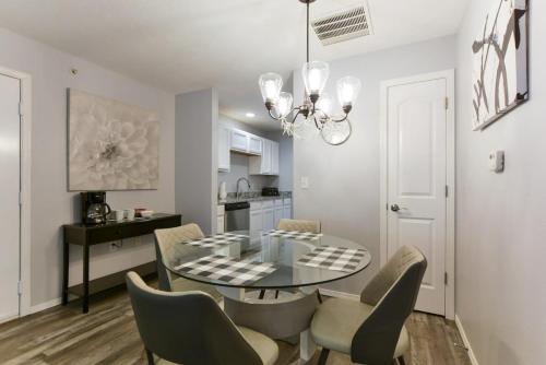 a dining room with a glass table and chairs at Glam R Us - Pool - Fabulous Location Must Stay in Branson