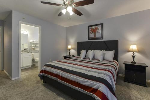 a bedroom with a bed and a ceiling fan at Glam R Us - Pool - Fabulous Location Must Stay in Branson