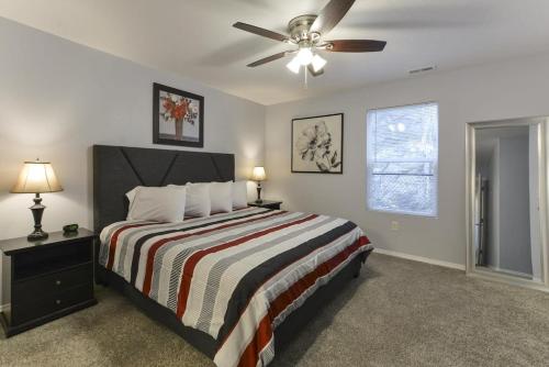 a bedroom with a bed and a ceiling fan at Glam R Us - Pool - Fabulous Location Must Stay in Branson