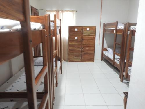 a room with a bunch of bunk beds at Pacifico Seaside Lodge in Moalboal