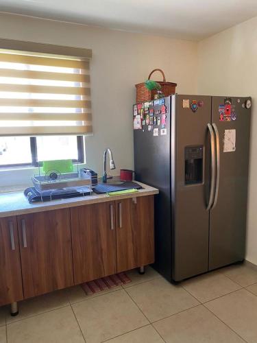a kitchen with a stainless steel refrigerator and a counter at Casa MAGIA in Alcocer