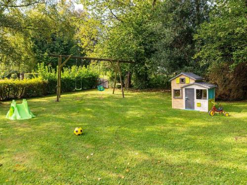 a dog house and a soccer ball in a yard at Grand Villa with Bubble Bath in Ferrières