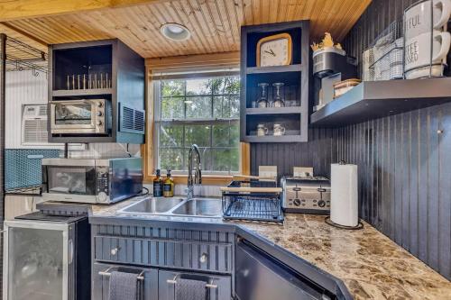 a kitchen with a sink and a counter top at Bare Feet Bunkhouse-Close to beach & dog friendly in Gulfport