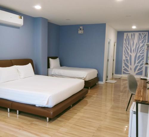 Postel nebo postele na pokoji v ubytování J-Boutique Hotel เจ-บูทีค โฮเทล