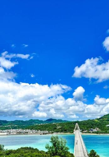a bridge over a body of water with a city in the background at ocean terrace SESOKO 301 in Ufugumui
