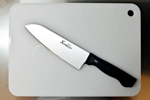 a knife sitting on top of a white cutting board at ocean terrace SESOKO 301 in Ufugumui