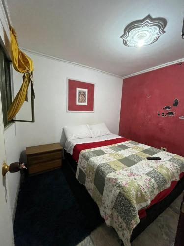 a bedroom with a bed with a quilt on it at Apartamento doña Esperanza in Vergara