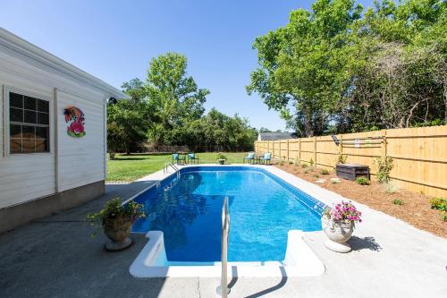 a swimming pool in the backyard of a house at Coastal Home with Inground Pool in Wilmington