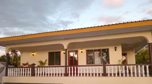 a small house with a balcony at Dream Paradise Apartment in Korotogo