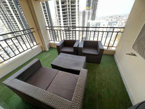a balcony with a table and chairs on a building at Three-bedroom Urban Retreat with Terrace AQZ Apartments in Humak