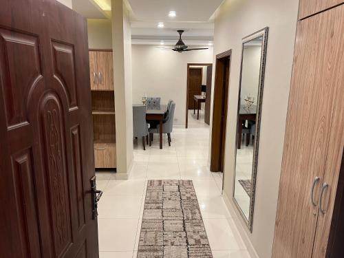 a hallway with a door and a dining room at Three-bedroom Urban Retreat with Terrace AQZ Apartments in Humak