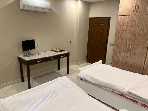 a hospital room with two beds and a desk at Three-bedroom Urban Retreat with Terrace AQZ Apartments in Humak