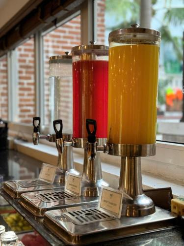 two pitchers of beer sitting on top of a counter at TTC Hotel - Hoi An in Hoi An
