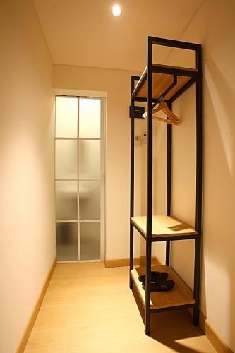 a room with a shelf and a closet at Mimaru Hotel Jakarta Mangga Besar in Jakarta