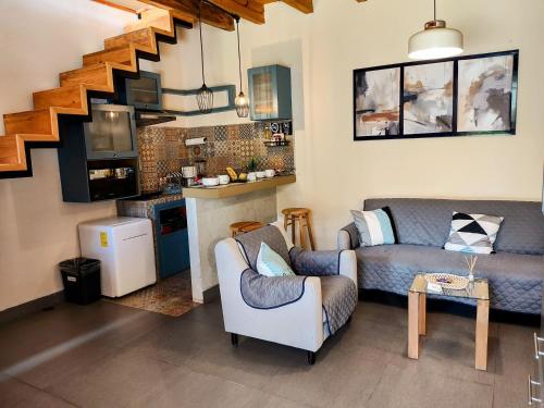 a living room with a couch and a staircase at Hotel Jardines Del Carmen in San Cristóbal de Las Casas