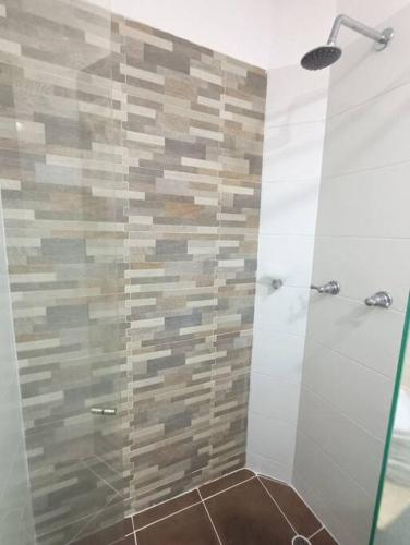 a bathroom with a shower with a glass door at Moderno y central apartamento in Vallecito
