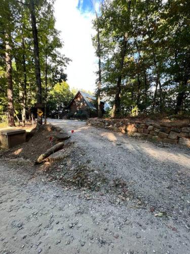 a dirt road in front of a house with trees at Ultimate Log Cabin Experience with BREATHTAKING Views in Yonah