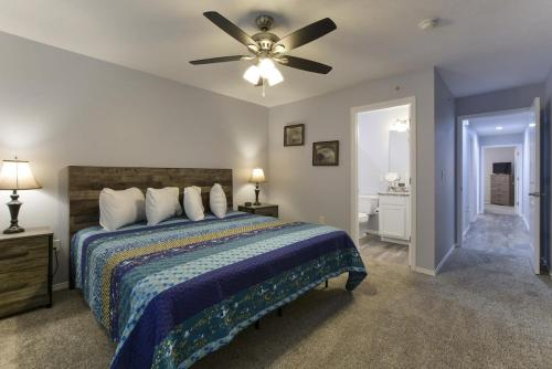 a bedroom with a bed and a ceiling fan at Western Comfort in Branson