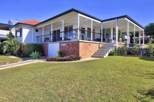 a house with a large lawn in front of it at Summer Salt - 13-15 Sturt Street South West Rocks in South West Rocks