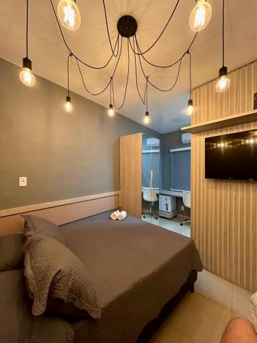 a bedroom with a bed and a chandelier at Cine Rio Hostel RJ in Rio de Janeiro