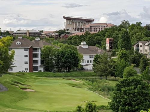 a view of a golf course with buildings in the background at Shelter in Faith- Amazing Golf Views in Branson