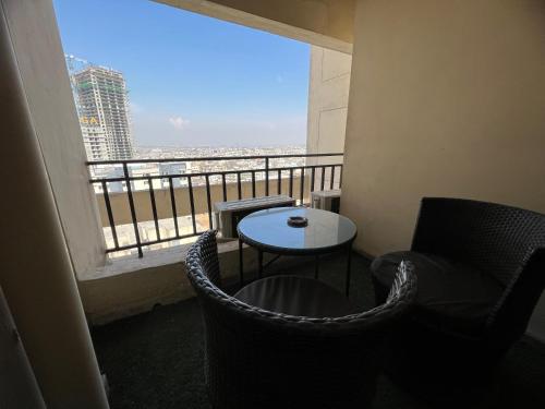 a balcony with a table and chairs and a window at Three-bedroom Urban Retreat with Terrace AQZ Apartments in Humak
