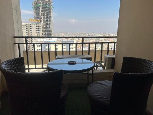 a balcony with a table and chairs and a view at Three-bedroom Urban Retreat with Terrace AQZ Apartments in Humak