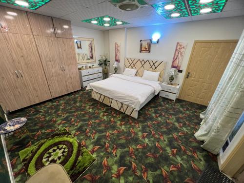 a bedroom with a bed and a room with cabinets at Three-bedroom Urban Retreat with Terrace AQZ Apartments in Humak
