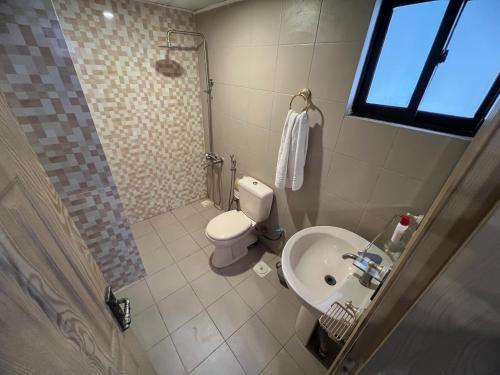 a small bathroom with a toilet and a sink at Three-bedroom Urban Retreat with Terrace AQZ Apartments in Humak
