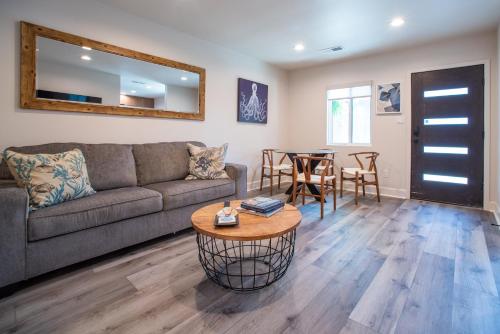 a living room with a couch and a table at Modern Ocean Beach Apartment in San Diego
