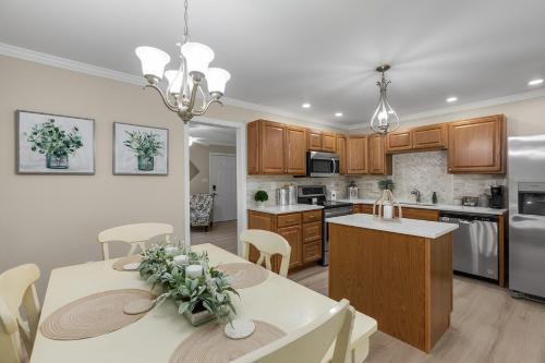 a kitchen and dining room with a table and chairs at Coastal Home with Inground Pool in Wilmington