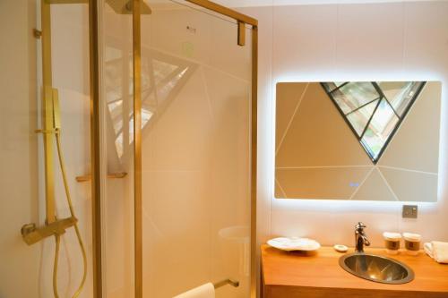 a bathroom with a sink and a shower at 东山一个庐野奢帐篷营地 in Yanya