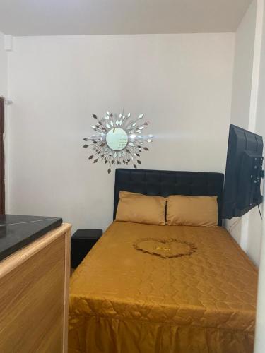 a small bedroom with a bed and a chandelier at Conjugado Próximo aos Arcos da Lapa e Praia do aterro do Flamengo in Rio de Janeiro