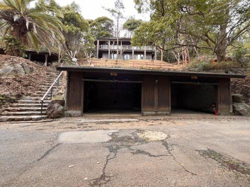 a garage with a building on top of it at トラストメゾン一碧湖 in Ogi