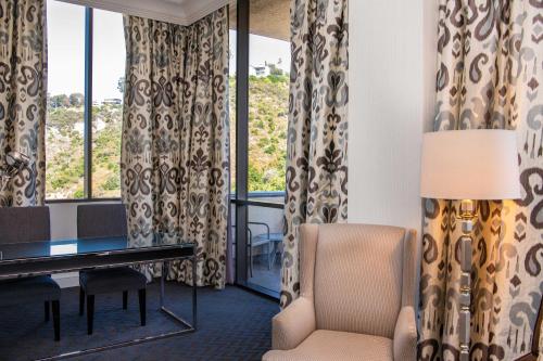 a living room with a desk and a chair at Sheraton Mission Valley San Diego Hotel in San Diego