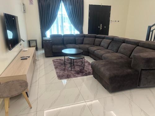 a living room with a couch and a table at Jenny Homestay in Teluk Intan